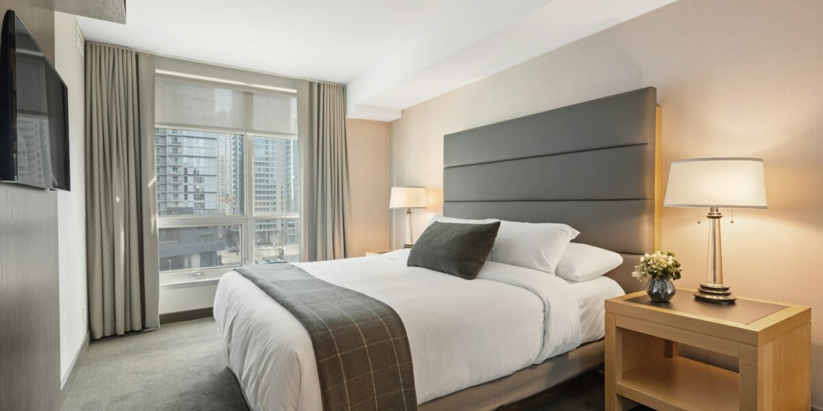 Made bed with white linen in a calm bedroom