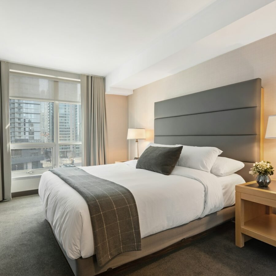 Made bed with white linen in a calm bedroom