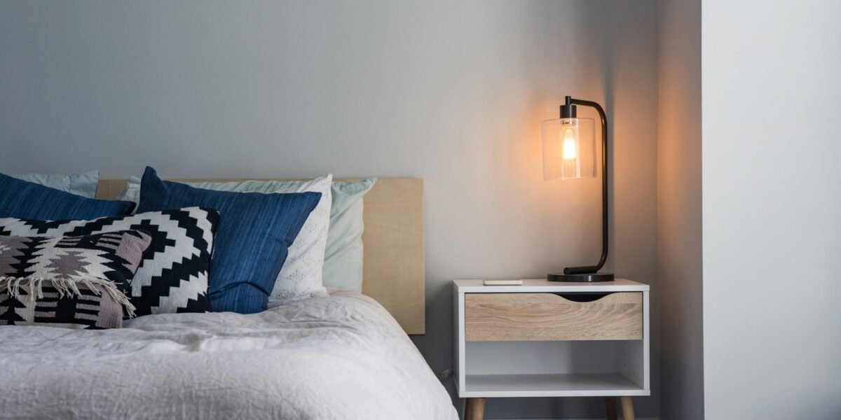 Soft bed with pillows in warm evening light