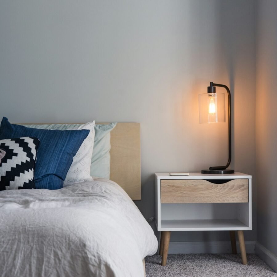Soft bed with pillows in warm evening light