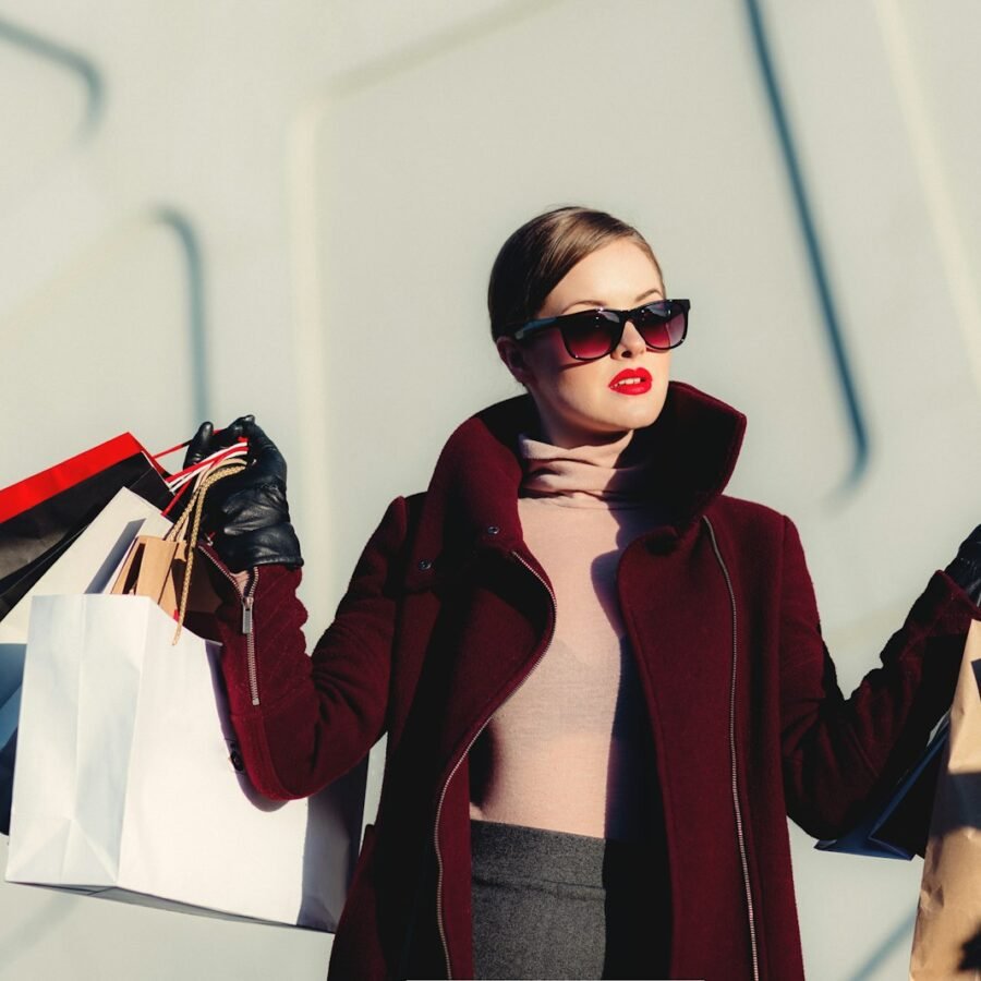 Woman in a tailored camel coat shopping in the city